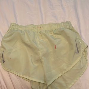 Neon yellow Nike shorts. Has a few paint marks.